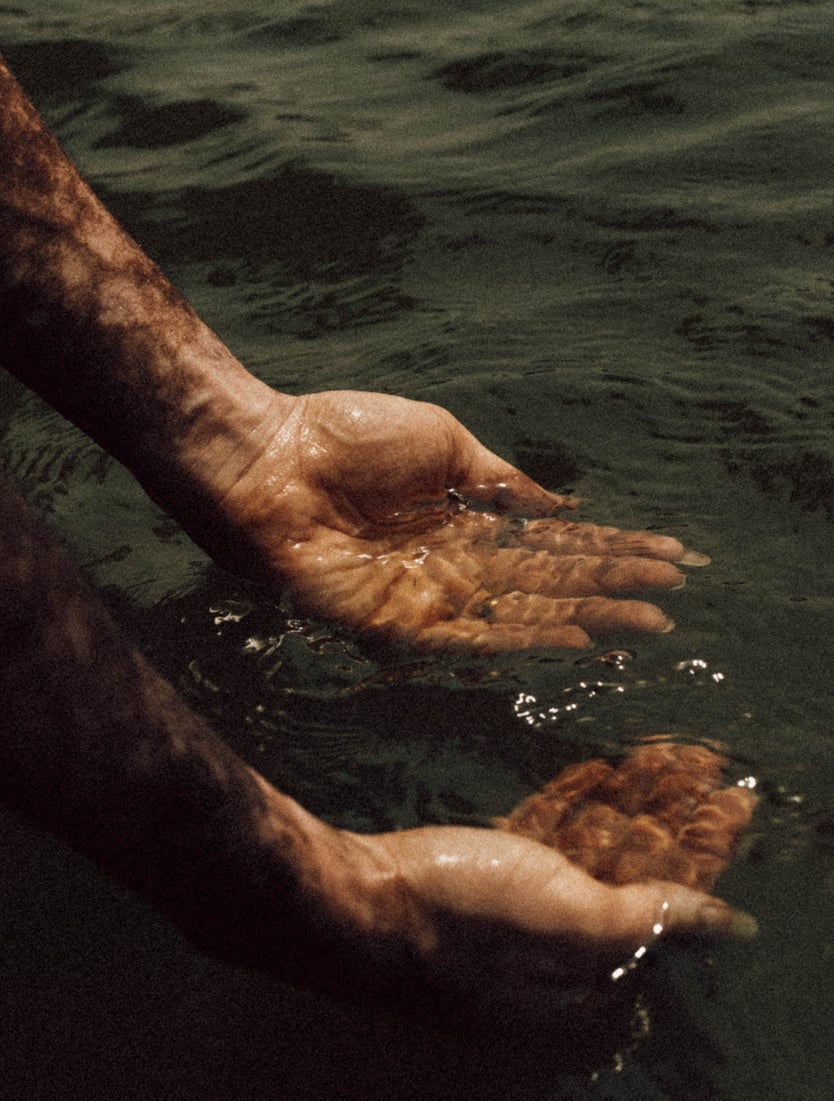 Persons Hands on Water